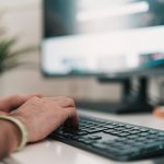 person using black and silver computer keyboard